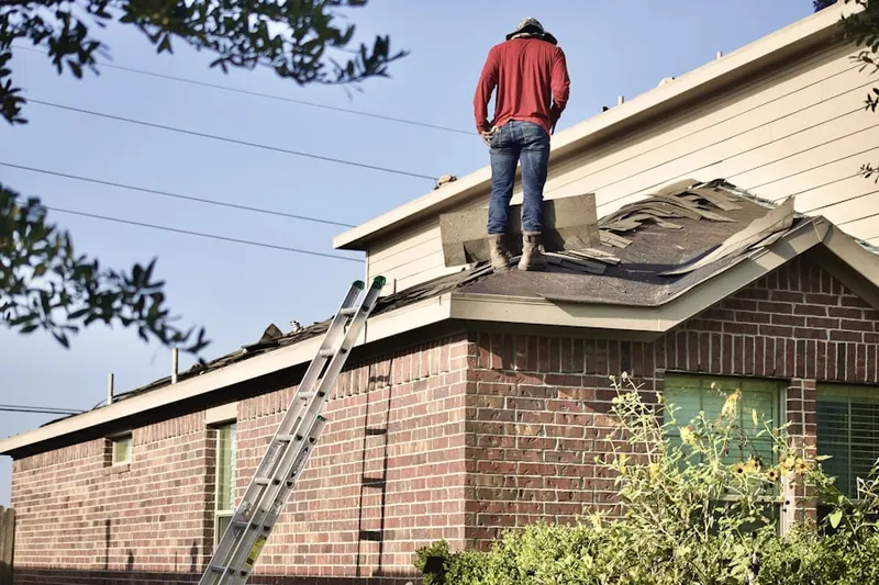 Professional roofer working on a residential roof in Flair Park